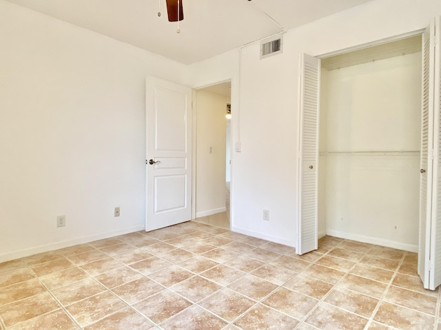 6928 Briarlake Cir Unit 104, Palm Beach Gardens, FL 33418 - unfurnished bedroom with light tile patterned flooring, a closet, ceiling fan, and baseboards