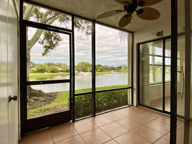 6928 Briarlake Cir Unit 104, Palm Beach Gardens, FL 33418 - unfurnished sunroom with a water view and tile patterned floors