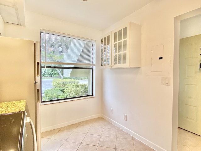 6928 Briarlake Cir Unit 104, Palm Beach Gardens, FL 33418 - unfurnished dining area with light tile patterned floors, baseboards, and electric panel