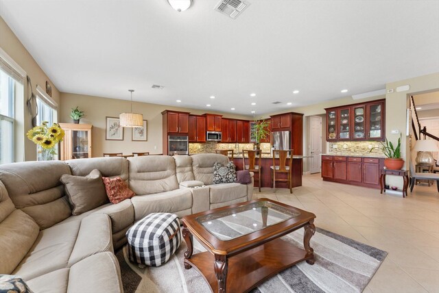 kitchen with dishwasher, light stone countertops, plenty of natural light, and sink