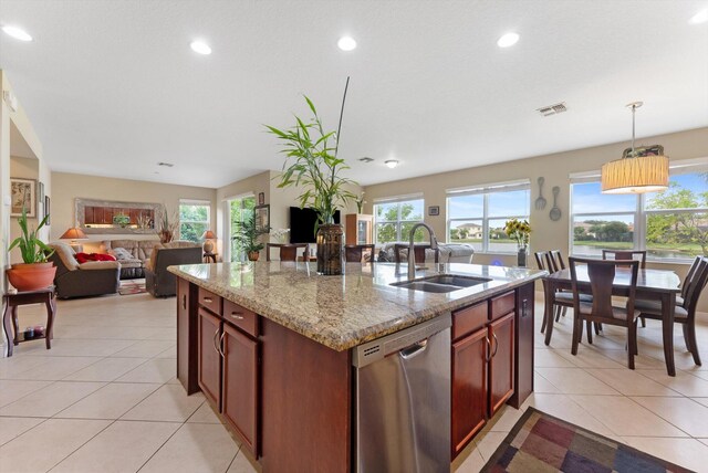 kitchen with light tile patterned floors, tasteful backsplash, stainless steel refrigerator, and light stone counters