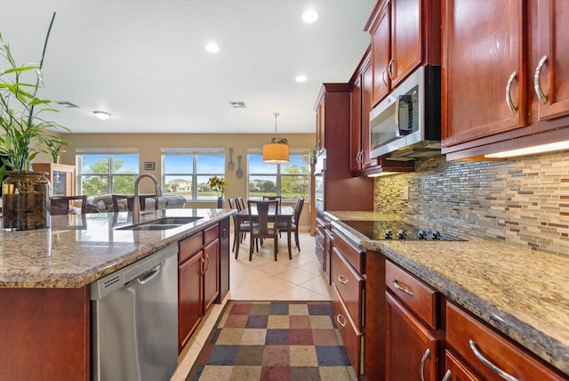 tiled dining room with a wealth of natural light and sink