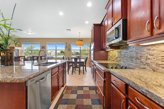 tiled dining room with a wealth of natural light and sink