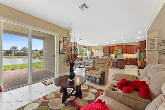 bedroom with hardwood / wood-style flooring, ceiling fan, connected bathroom, and a tray ceiling