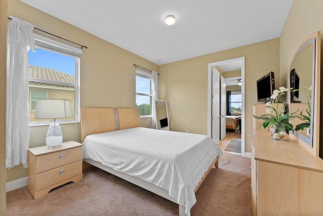 bedroom with ceiling fan and light colored carpet