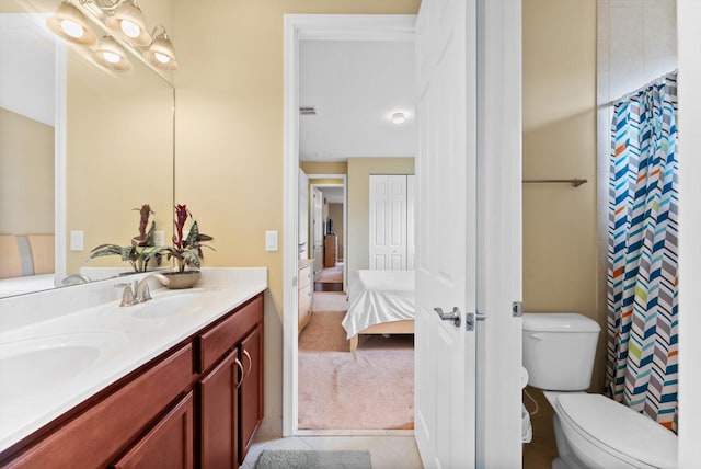 bedroom featuring light carpet, connected bathroom, and ceiling fan