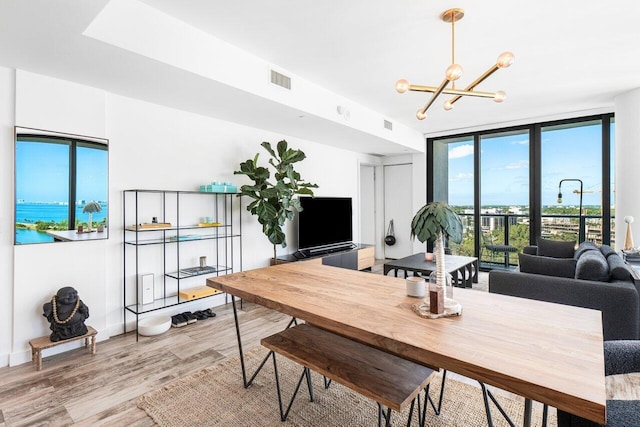 dining space featuring a chandelier and light wood-type flooring