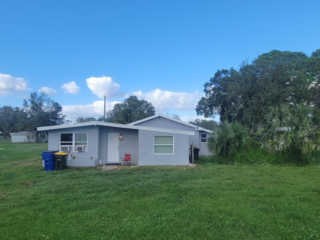 rear view of house featuring a lawn