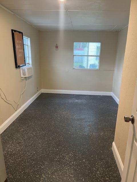 spare room featuring a paneled ceiling and cooling unit