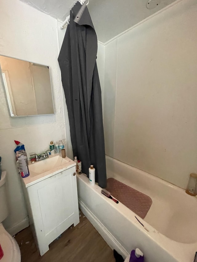 full bathroom featuring toilet, vanity, shower / tub combo with curtain, and hardwood / wood-style flooring