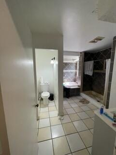 bathroom with tile patterned flooring and toilet