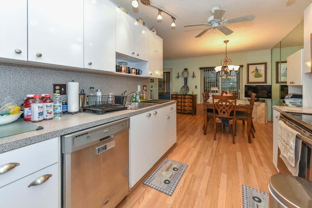 kitchen with light hardwood / wood-style flooring, pendant lighting, a textured ceiling, white cabinets, and appliances with stainless steel finishes