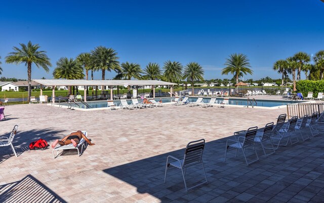 surrounding community featuring a water view and a lawn