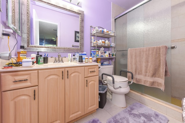 bathroom with tile patterned flooring, vanity, toilet, and a shower with shower door