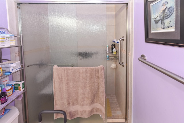 bathroom featuring toilet and walk in shower