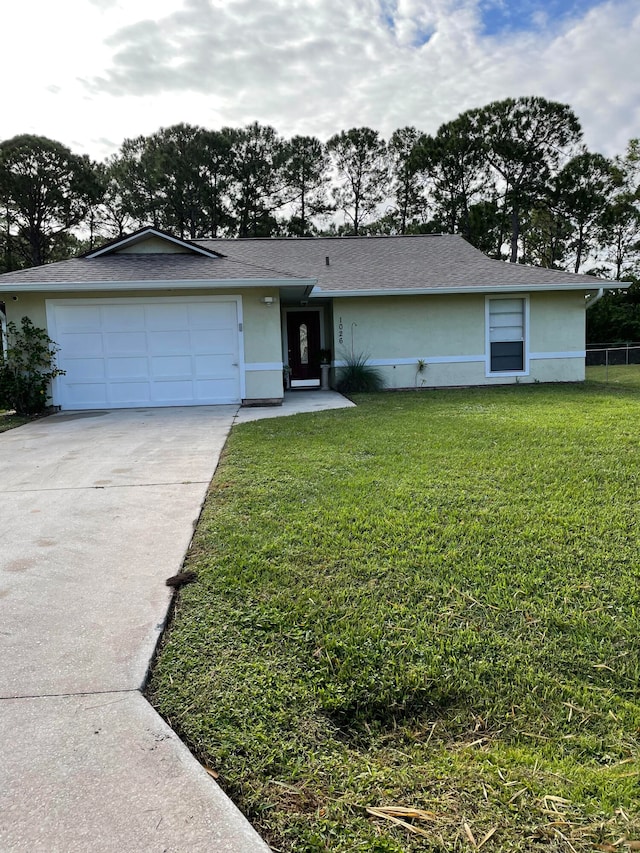 single story home with a garage and a front yard