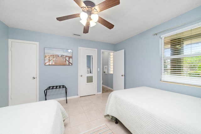 tiled bedroom with ceiling fan