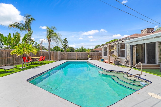 view of swimming pool featuring a patio area