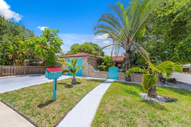 view of front of home with a front lawn and a garage