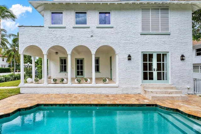 back of house with french doors and a patio