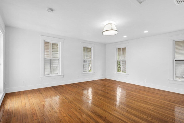 spare room with hardwood / wood-style floors