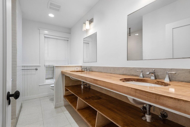 bathroom featuring tile patterned floors, vanity, and toilet