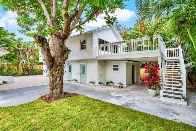 view of front of house with a front lawn and a deck