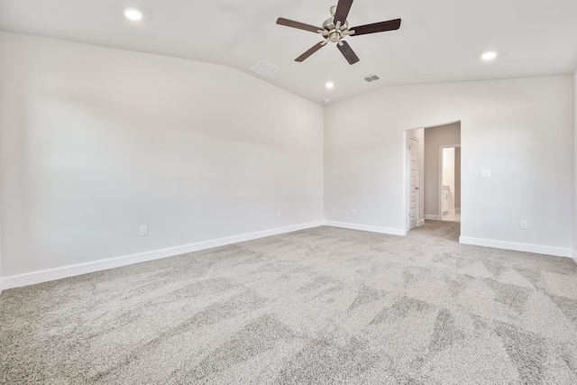 carpeted spare room featuring ceiling fan and vaulted ceiling