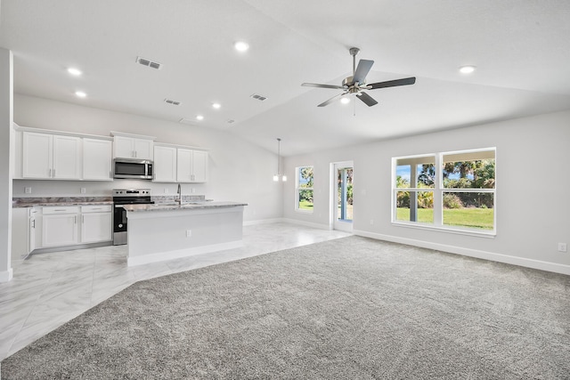 unfurnished living room with ceiling fan, sink, lofted ceiling, and light carpet