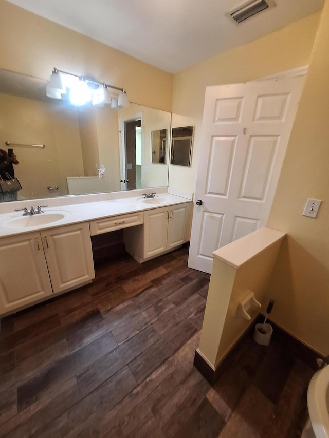 bathroom with hardwood / wood-style flooring and vanity