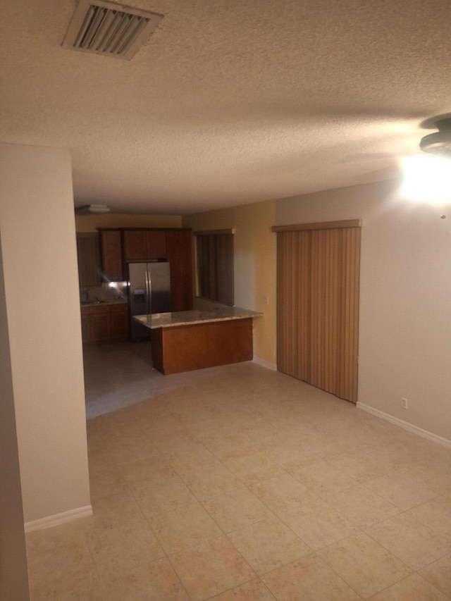 unfurnished living room with a textured ceiling