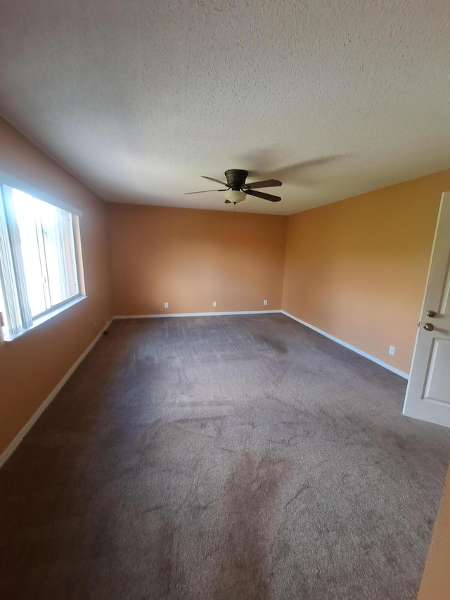 carpeted empty room featuring a textured ceiling and ceiling fan