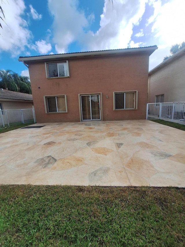 back of house with a patio