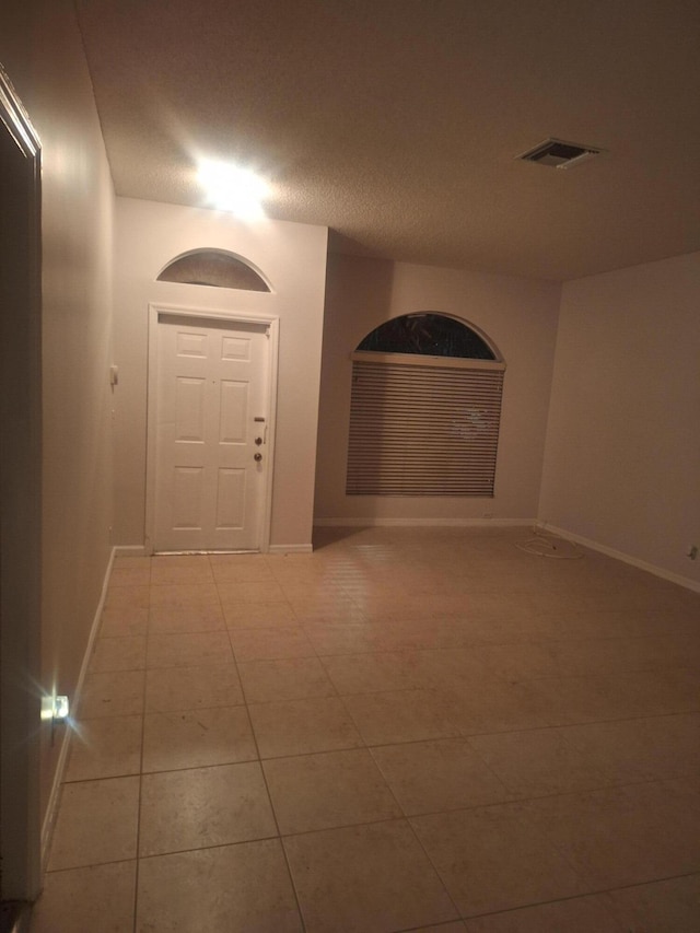 hall featuring light tile patterned floors