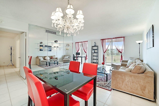 living room featuring a chandelier, light tile patterned floors, and a textured ceiling