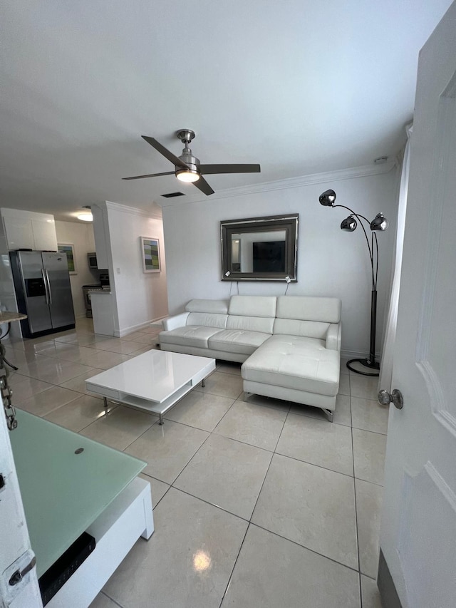 tiled living room featuring ceiling fan and crown molding