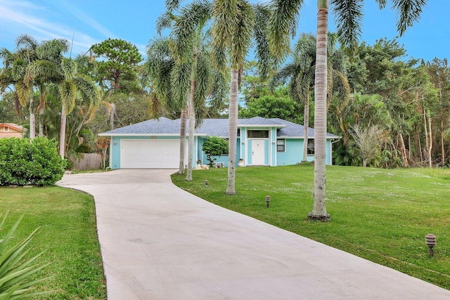 view of front facade featuring a front yard and a garage