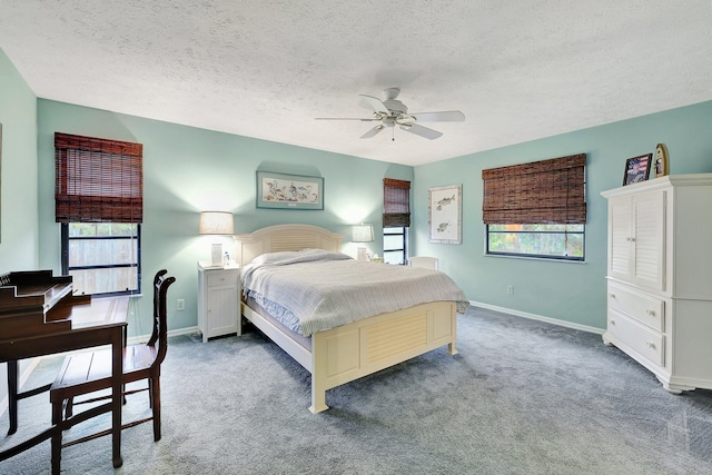 bedroom featuring carpet, a textured ceiling, and ceiling fan