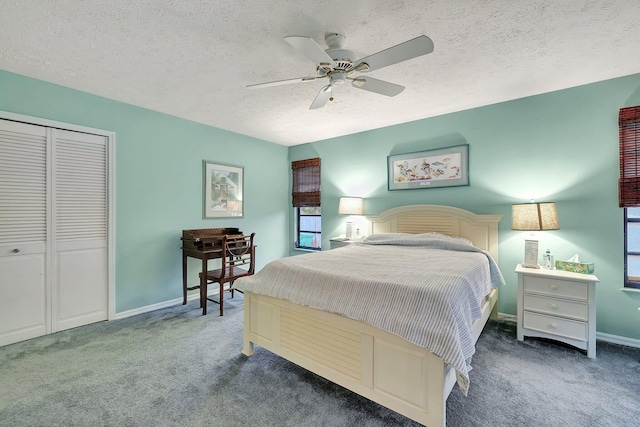 carpeted bedroom featuring ceiling fan, a textured ceiling, and a closet