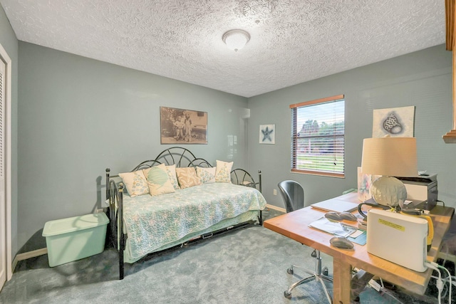 bedroom with carpet and a textured ceiling