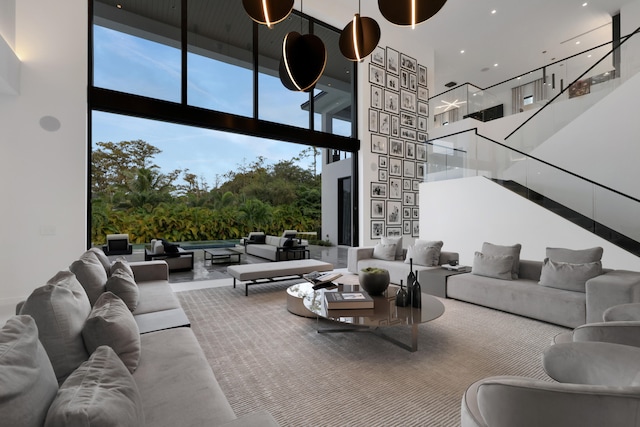 living room with a towering ceiling and expansive windows