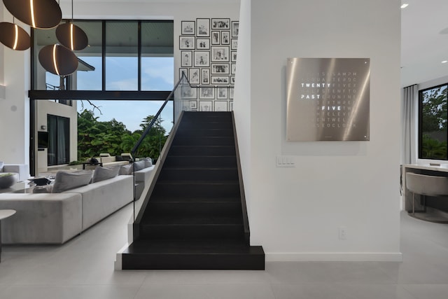 stairway with tile patterned floors