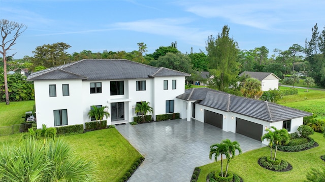 view of front facade featuring a front yard and a garage