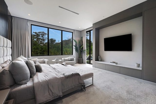 carpeted bedroom with floor to ceiling windows