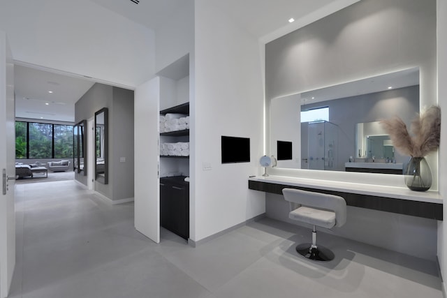 bathroom with vanity, concrete flooring, and an enclosed shower