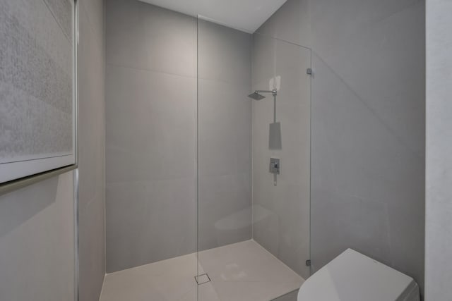 bathroom with a tile shower