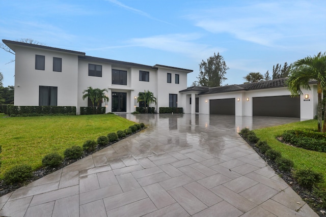 view of front of property with a front yard and a garage