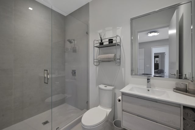 bathroom with vanity, toilet, and walk in shower