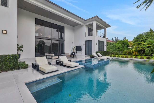 view of pool featuring an in ground hot tub and a patio