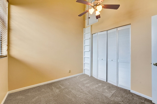 unfurnished bedroom featuring carpet flooring, a closet, and ceiling fan